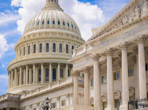 U.S. Capitol dome with blue sky background.