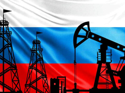 Silhouettes of oil rigs on Russian flag background.