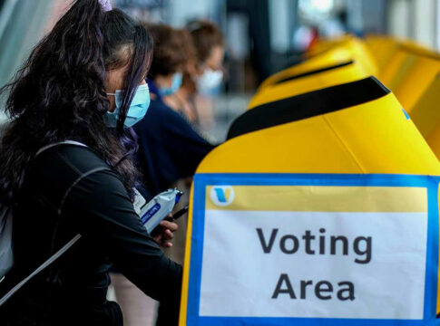 People voting at a polling station.
