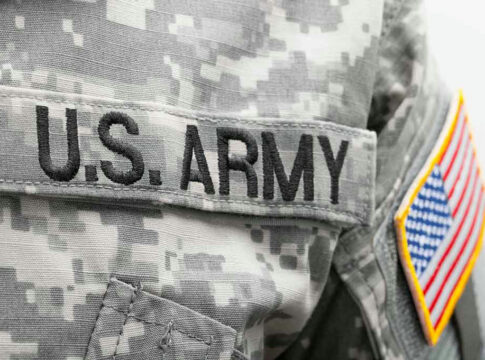 U.S. Army uniform with American flag patch.