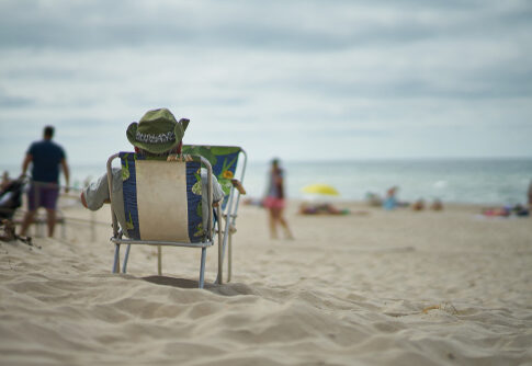 Person sitting in a beach chair overlooking the ocean