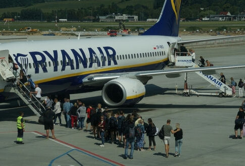 Passengers boarding a Ryanair plane at the airport.